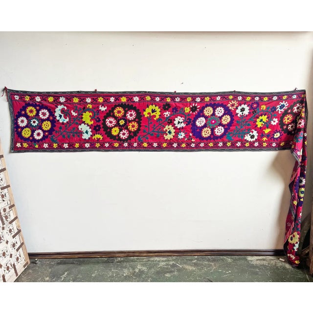 Vintage Suzani long runner textile. Hand embroidered decorative tribal textiles in bright colors on cotton or silk...