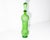 An Empoli green glass bottle that features a raised fruit design. Made in Italy, this light green bottle comes in a...