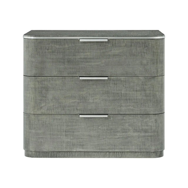 This elegant piece showcases a stunning combination of layered oak, stainless steel, and maple veneers, making it a...