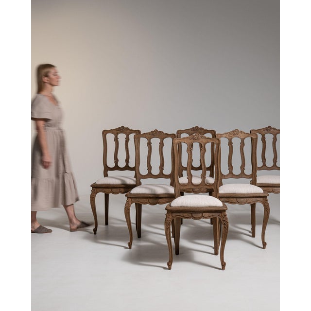 A set of dining chairs whose dark wood, cream upholstered seats gives it real character at first glance. Dating to 19th...