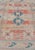 Measures: 4'5 x 6'7 This vintage Oushak has repeating motifs in terracotta, cream, and blue encasing multiple motifs and...