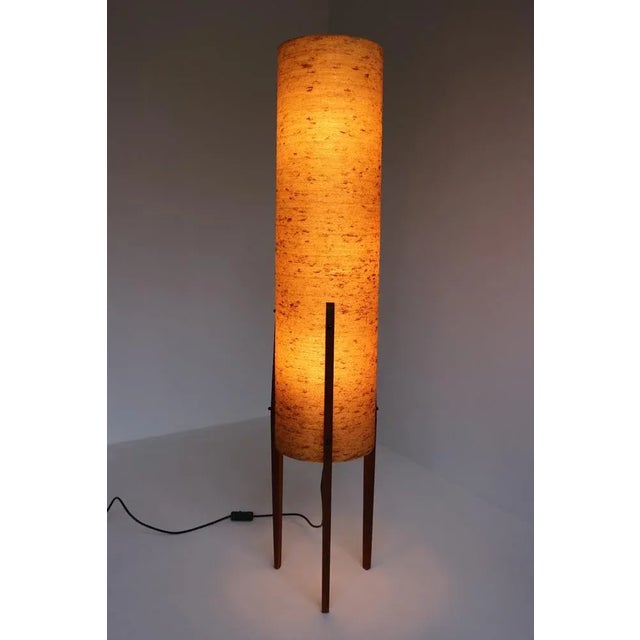 This tripod floor lamp from the 1960s, known as a "rocket light," is an iconic example of Mid-Century Modern design. Its...