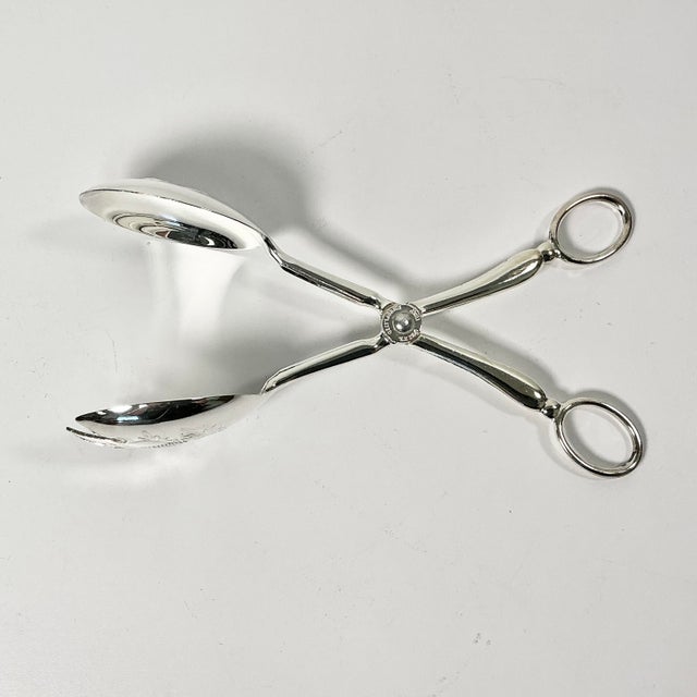 These silver plated salad tongs are by Towle Silver Co and manufactured in Italy. The are the traditional design of a...
