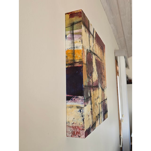 Contemporary signed abstract mixed media canvas featuring rich burgundy, gold, cream, and black tones with heavy texture...