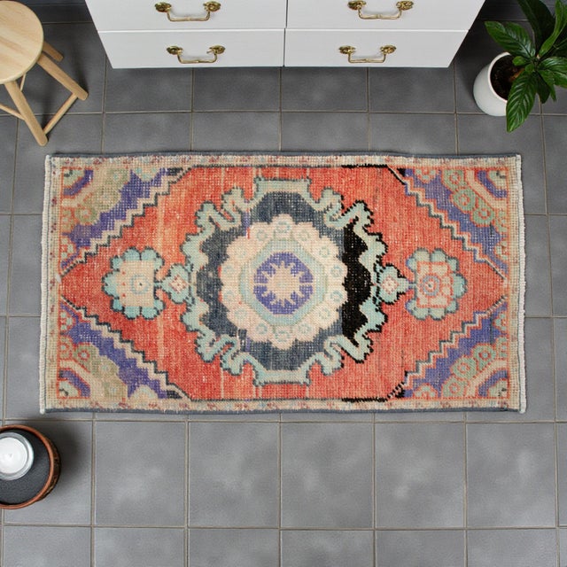 Welcome to our curated collection of authentic Anatolian textiles. This exquisite hand-knotted small rug brings a touch of...