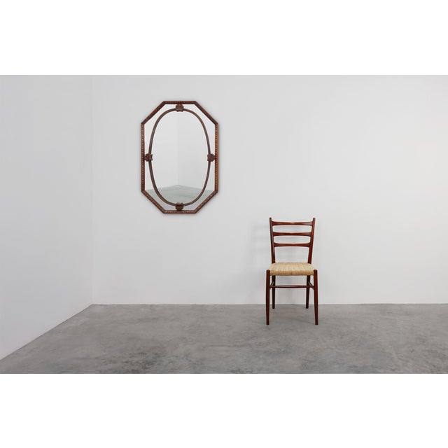 This French Art Deco mirror from the 1920s, beautifully combines geometric precision with elegant organic motifs....
