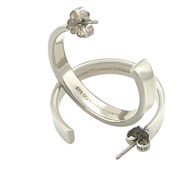 These Tiffany & Co. 1837 hoop earrings are crafted in sterling silver, featuring a sleek and timeless design from the...