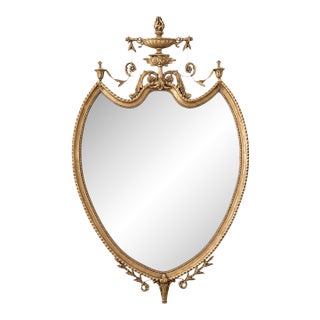 Giltwood Neoclassical Shield Wall Mirror With Urn Crest and Ornate Ribbon Swag For Sale