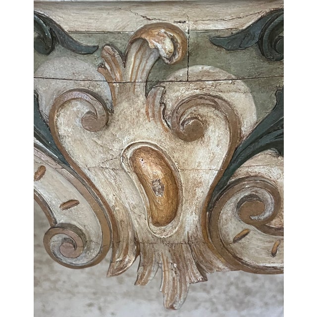 Antique Italian console table, made in Italy in the 19th Century. The table includes four cabriole legs, and hand carved...