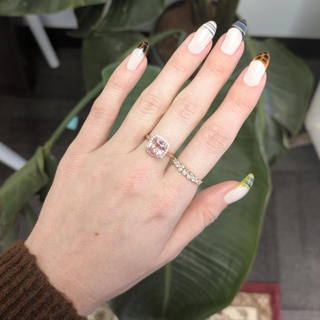 A radiant 2.9ct pink tourmaline glows at the center of a natural diamond halo. Crafted in solid 14K rose gold for a soft,...