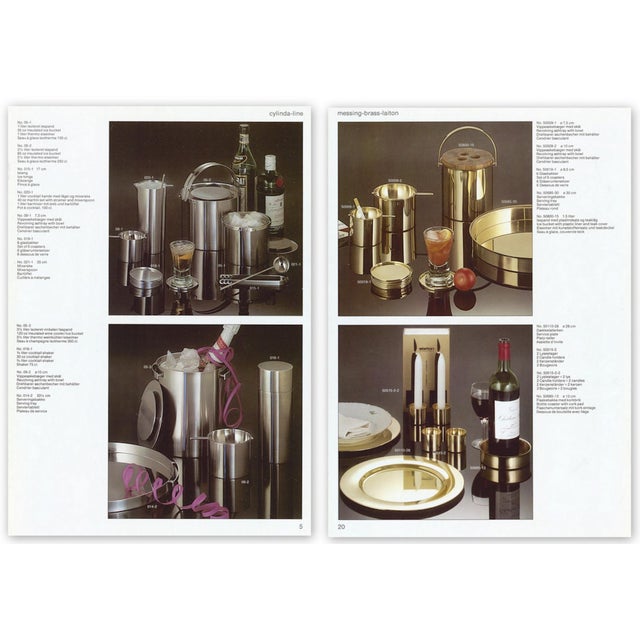 This brass ice bucket with a teak lid and a black plastic inner-bucket was designed by Arne Jacobsen in 1959-1960 for the...