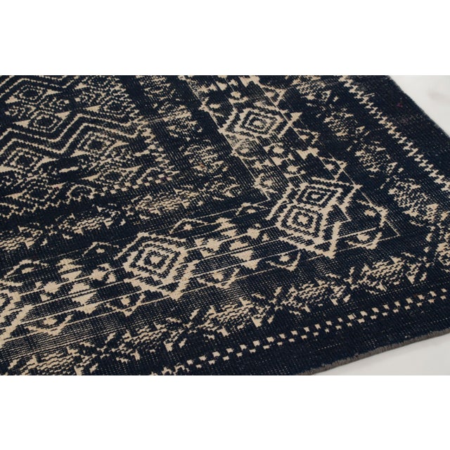 Hand-knotted in wool, this 8x10 contemporary rug features a dense geometric field inspired by Anatolian tribal motifs. It...