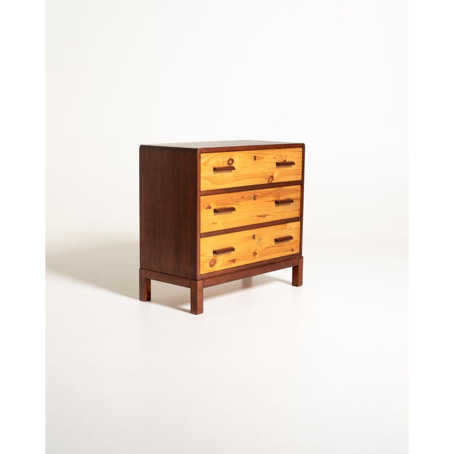 Art Deco chest of drawers with three large drawers, characterized by the contrast between the light birch fronts and the...