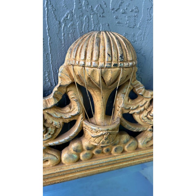 This is a cool mirror done in the French Empire style with a hot air balloon crest. It features a gold frame with a...