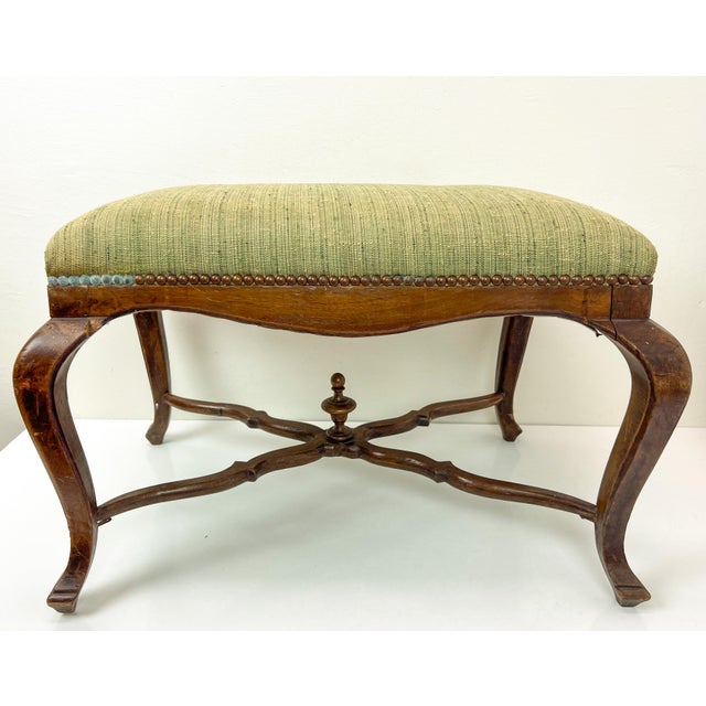Louis XV Style Walnut Bench or Stool with the authentic green upholstery, France late 19th Century. It stands on graceful...