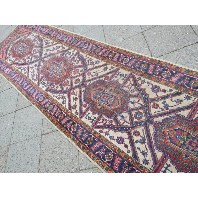 Antique Middle Eastern Heriz hand woven runner dating from the 1920s or 1930s with a striking Bakhshaish design on an...