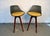 A stunning pair of vintage mid-century modern bar stools, likely by designers such as John Yellen or Chet Beardsley. These...