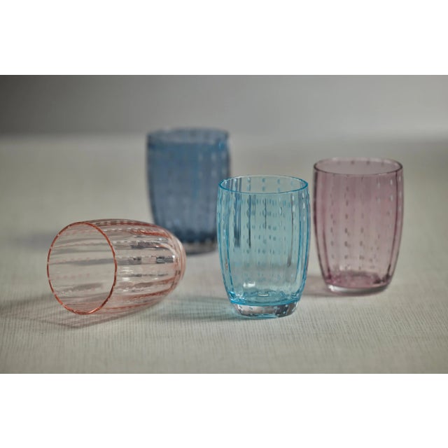 Spice up your dinner parties with glasses that shine. This set of 4 tumblers features colored glass with white dotted...