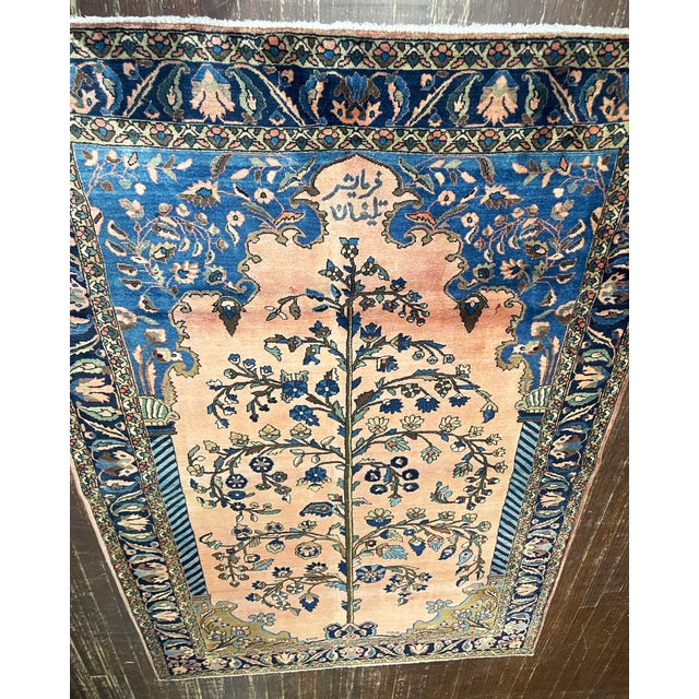 An exceptional antique Persian Mohajeran Sarouk dating to approximately 1910, masterfully woven with a magnificent Tree of...