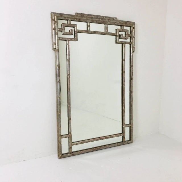 Faux silver leaf Greek key mirror. Mirror is in good vintage condition with wear due to age and use. Dimensions: 29" wide...
