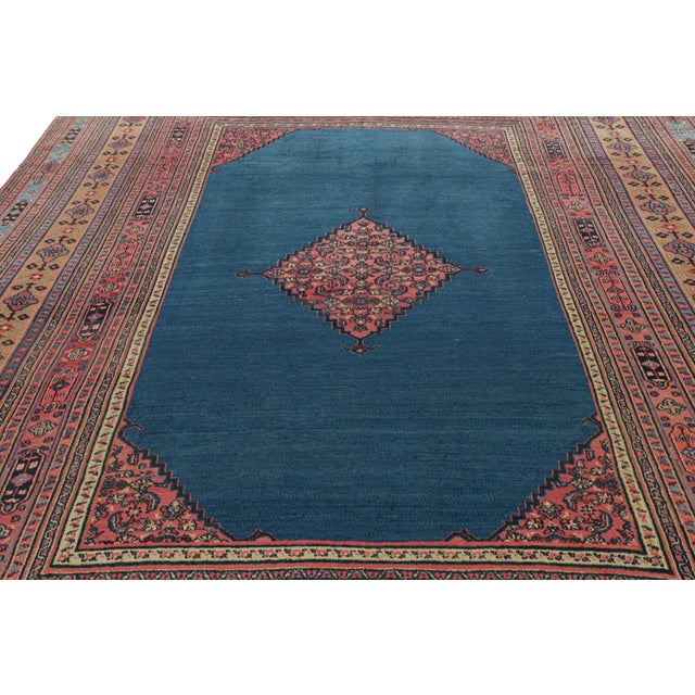 Made with hand-knotted wool and originating from Persia circa 1900-1910, this 10x13 antique Doroksh rug features a...