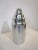 A very large aluminum party or hotel sized cocktail shaker with built in strainer to the lid and small cap . This would be...