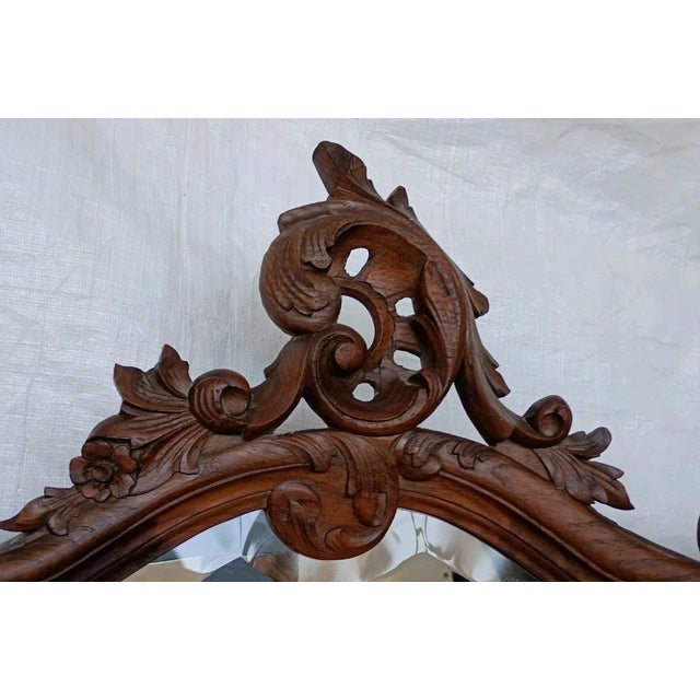 A striking antique French batwing mirror featuring beautifully figured quarter-sawn tiger oak, an elegantly carved crest,...