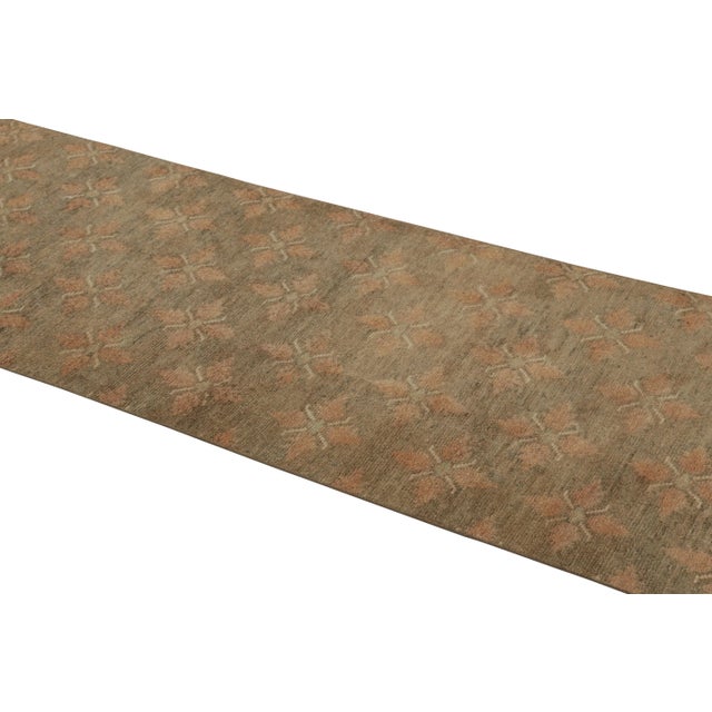 This vintage runner rug is a 3x9 Turkish distressed piece, made with hand-knotted wool circa mid-20th century. It is an...