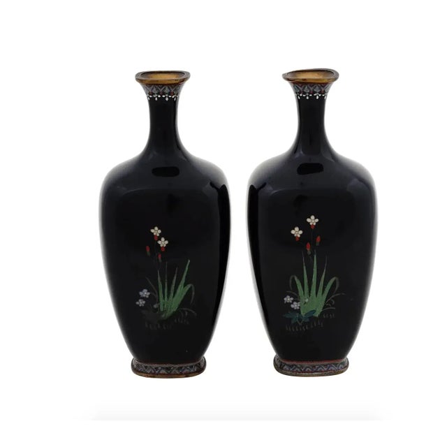 A pair of antique Japanese, late Meiji period, silver wire enamel vases. Each vase has an amphora shaped body and a fluted...