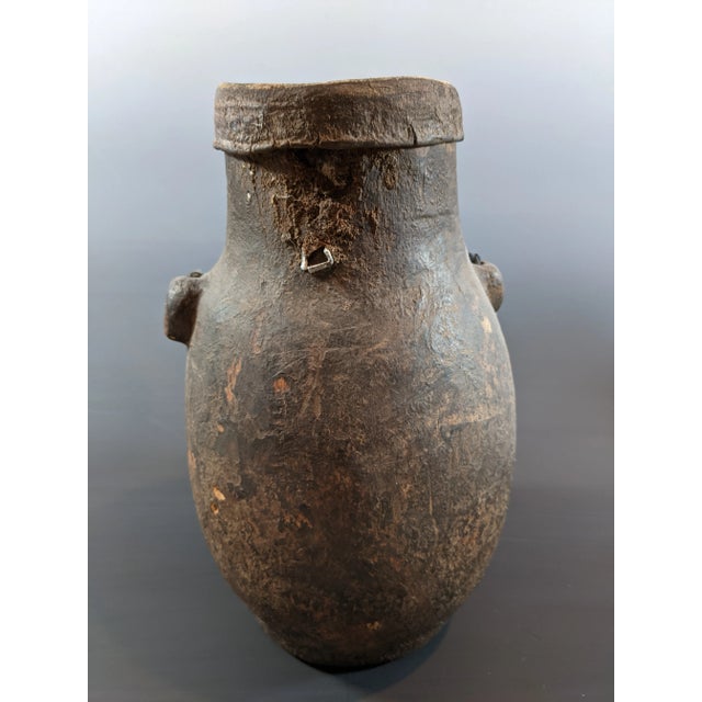 Antique African jug made with wood and leather Provenance unknown. Has a lovely antique patina as an object. Please note...