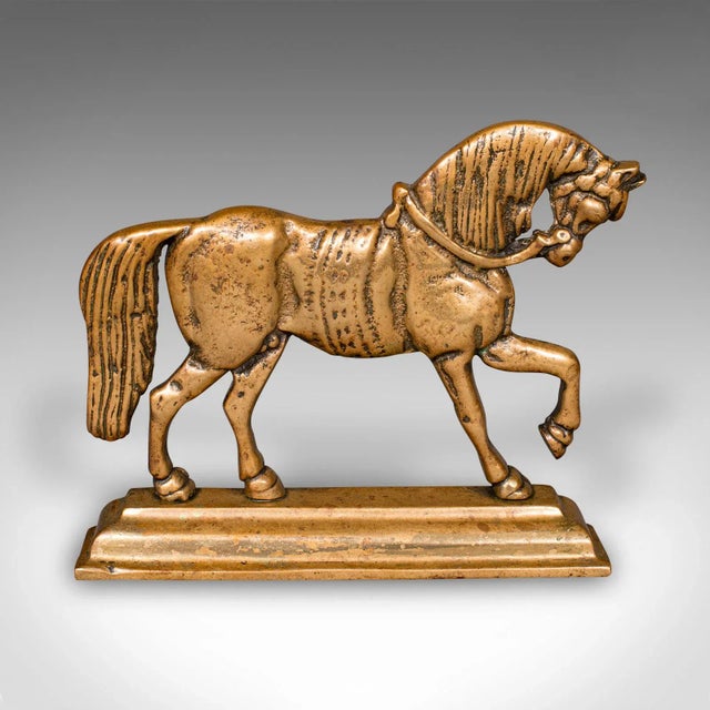 This is an antique horse doorstop. An English, brass equine door keeper, dating to the late Victorian period, circa 1880....