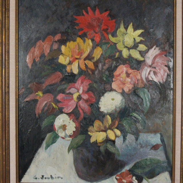 A vibrant and colourful oil painting of a bouquet in bloom, unusually set against a dark background. Signed to lower left....