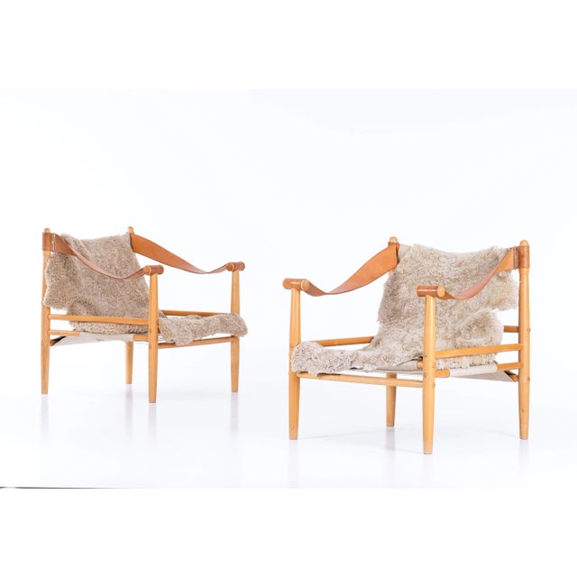 Pair of armchairs / safari chairs by Lennart Bender with leather, canvas, and new sheepskin. This piece is attributed to...