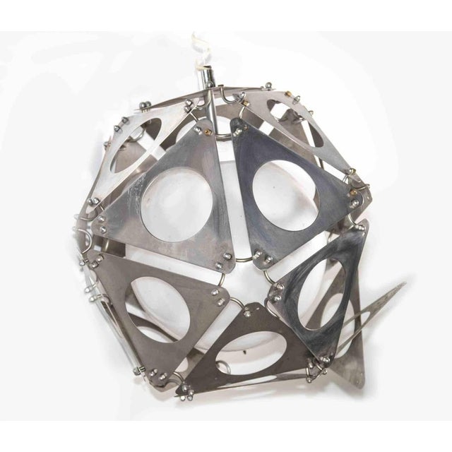 Poliedric Lamp is a design chandelier lamp realized in the 1970s. A vintage lamp with a metal geometric structure composed...