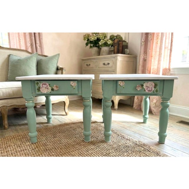 Constructed of wood and hand-refinished in a custom-mixed soft green finish with champagne gold leafing and bold floral...