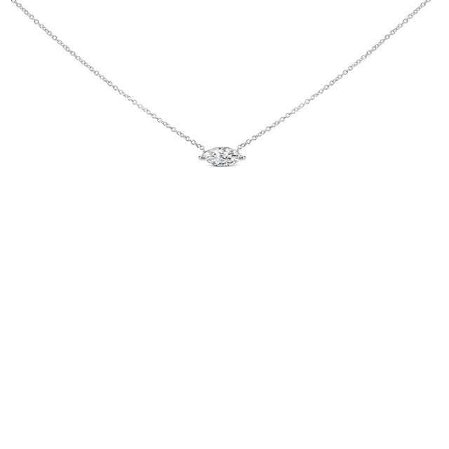 Experience the refined elegance of this 14K white gold pendant necklace, where modernity and luxury harmonize to create a...