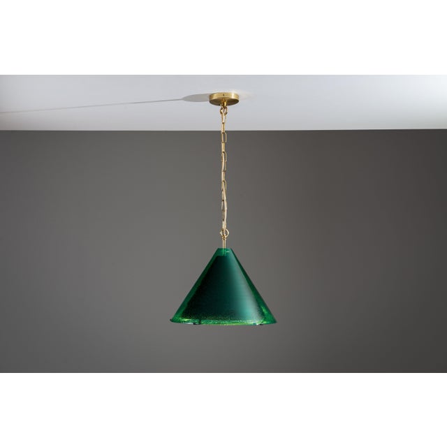 This rare and elegant pendant lamp is a refined example of Scandinavian lighting design from the 1960s, produced by the...