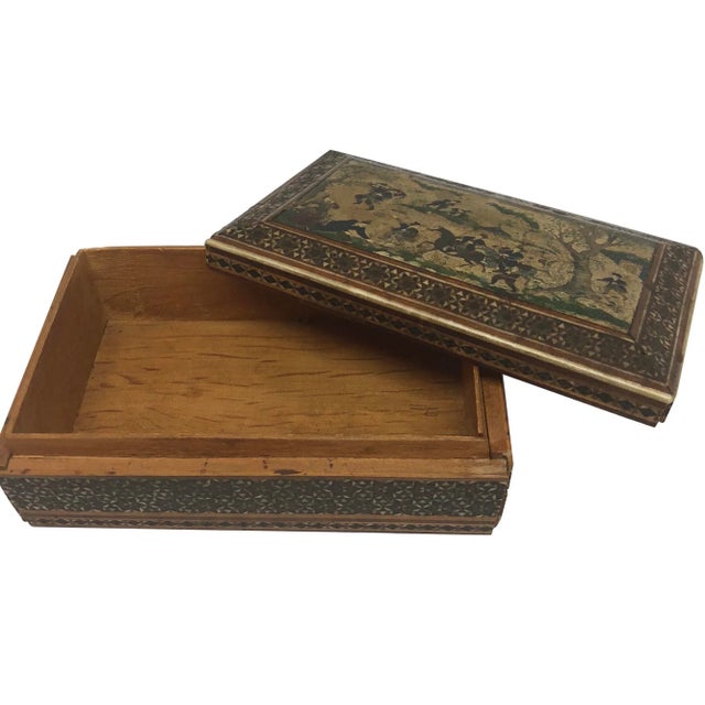 A fine 19th Century Persian box with a painted lid and intricate hardwood inlays. The rectangular top has a border inlaid...