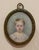 Antique portrait miniature of a small child, looking slightly unhappy. Watercolor on hard surface, signed CSP (the S might...