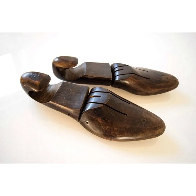 • Pair of vintage wood shoe lasts made by J.V. Shoe Tree Co, Brockton, Mass. • Center metal bracket. • Size 10B imprinted...
