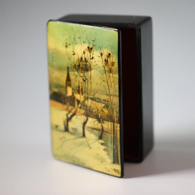 A vintage Soviet Fedoskino lacquer box, hand-painted after Aleksei Savrasov’s Грачи прилетели. The lid shows the well-...