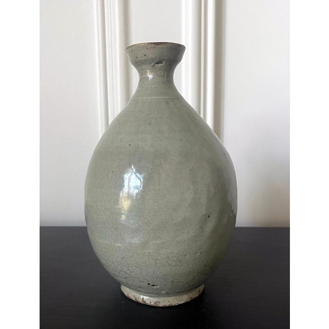 A Korean ceramic bottle-form vase circa 16th century Joseon Dynasty. It was likely intended as a wine bottle, the pear-...
