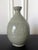 A Korean ceramic bottle-form vase circa 16th century Joseon Dynasty. It was likely intended as a wine bottle, the pear-...