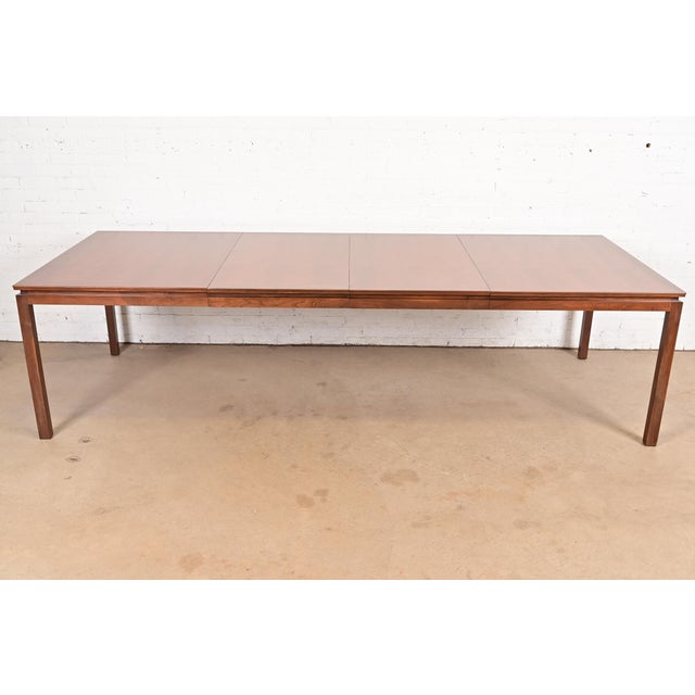 An exceptional Mid-Century Modern walnut extension dining table By Edward Wormley for Dunbar Furniture USA, 1950s...