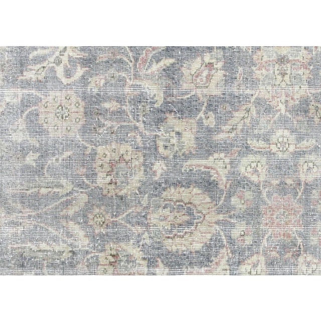 A vintage Turkish Oushak measuring 6'7" x 10', hand-woven with wool on wool foundation. This piece displays the region's...