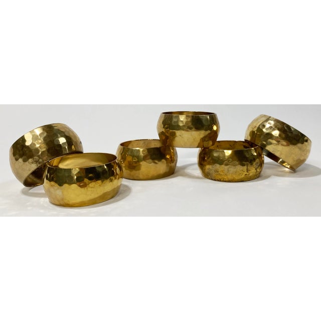 Chic vintage set of six round hammered brass napkin rings. Lovely patina.