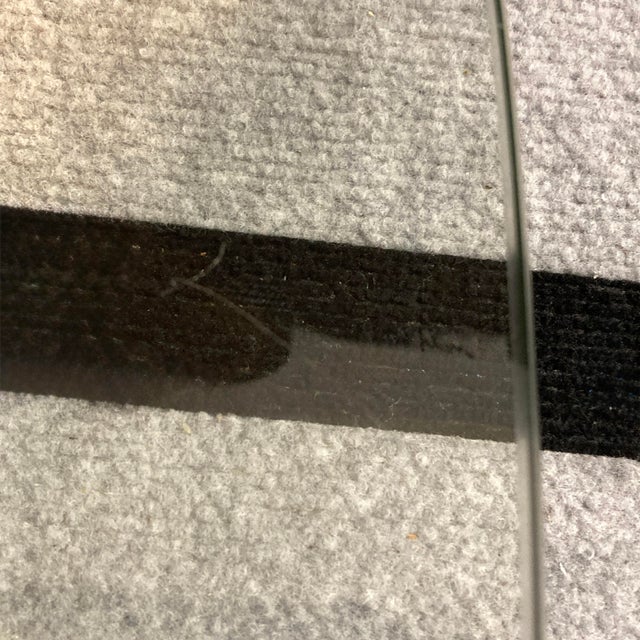 Small, low height coffee table with a black lacquered wood base and a glass top. Condition: Good vintage condition, some...