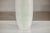 "About the Item This artisan ceramic vase is distinguished by its elegant, elongated silhouette and understated white...