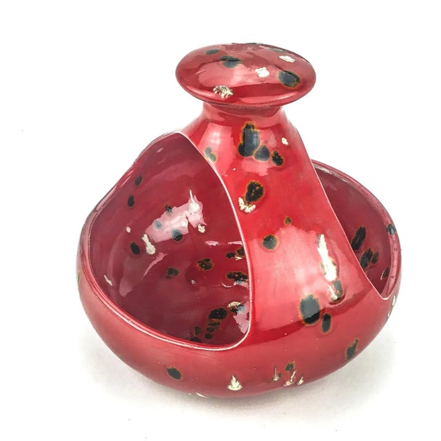 Nice vintage piece with a very unusual glaze. The bright red color will add a pop star feeling to your kitchen or table....