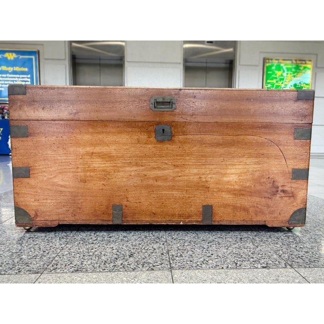 Hand-crafted in the 19th Century, this English campaign chest is made of sturdy camphor wood with brass mounts and...